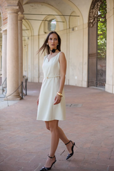 a lady in a white dress with a belt
